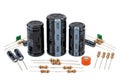 Assorted electronic components including capacitors, resistors, and diodes on white background Royalty Free Stock Photo