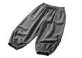 A pair of dark grey, elasticated, wide-legged pants with a drawstring waist Royalty Free Stock Photo