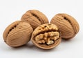 Three whole walnuts with one cracked open revealing its edible seed inside Royalty Free Stock Photo