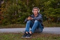 Upset teenager sitting on the ground.