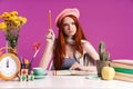 Image of displeased teenage girl studying with exercise books while sitting at desk Royalty Free Stock Photo