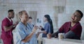 Image of dna strand and binary coding data processing over diverse doctors in hospital Royalty Free Stock Photo