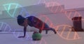 Image of dna strands spinning over woman doing press ups, exercising with ball in gym Royalty Free Stock Photo