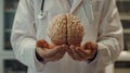 In this image, the doctor is wearing a white coat and has a brain above his hands. He is performing neurosurgery. He is