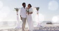 Image of dots over happy african american newly married couple on beach Royalty Free Stock Photo