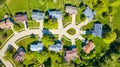 Downward rooftop view of eight suburban neighborhood homes of varying colors aerial Royalty Free Stock Photo