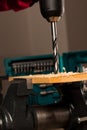 Image of drilling hole in wood clamped in vice tool. Royalty Free Stock Photo