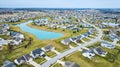 Drone aerial of suburban Midwest American neighborhood houses with pond