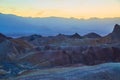 Dusk golden light hitting colorful mountains in Death Valley