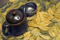 Image of eastern teapot and teacups on leaves