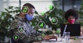 Image of ecology icons over african american businessman wearing face mask and using computer