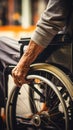 image of an elderly hand gripping a wheelchair rim, symbolizing aged resilience and mobility