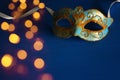 Image of elegant blue and gold venetian, mardi gras mask over dark background. Royalty Free Stock Photo