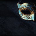 Image of elegant blue and gold venetian, mardi gras mask over dark background. Royalty Free Stock Photo