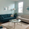 Elegant living room with teal blue wall with molding and room behind white and glass wall with big baseboard Royalty Free Stock Photo