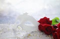 Image of elegant venetian mask and red roses over wooden table Royalty Free Stock Photo