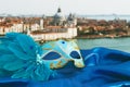 Image of elegant venetian mask on silk fabric in front of blurry Venice background. Royalty Free Stock Photo