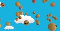 Image of emoticons floating over blue sky with clouds Royalty Free Stock Photo