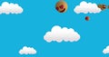 Image of emoticons floating over blue sky with clouds Royalty Free Stock Photo
