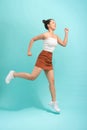 Image of emotional young lady jumping isolated over white background wall