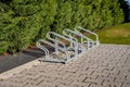 empty bicycle parking rack in front of a row of hedges Royalty Free Stock Photo