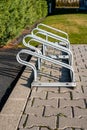 empty bicycle parking rack in front of a row of hedges Royalty Free Stock Photo