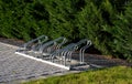 empty bicycle parking rack in front of a row of hedges Royalty Free Stock Photo