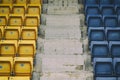 Empty rows with blue and yellow seats in open air stadium Royalty Free Stock Photo