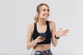 Image of energetic blond woman 20s dressed in sportswear using smartphone during workout in gym Royalty Free Stock Photo