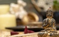 Buddha statue image on altar with candles and plants