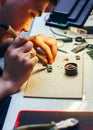 Image of engineer with soldering iron repairing mechanism Royalty Free Stock Photo