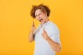 Image of european flirty guy 20s laughing and pointing finger at Royalty Free Stock Photo