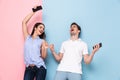 Image of excited man and woman wearing earphones listening to mu Royalty Free Stock Photo