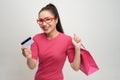 Image of excited screaming young woman standing holding shopping bags and credit card Royalty Free Stock Photo