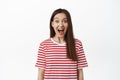 Image of excited surprised girl drop jaw, scream from amazement and looking at camera amazed, staring in awe at surprise Royalty Free Stock Photo