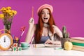 Image of excited teenage girl studying with exercise books while sitting at desk Royalty Free Stock Photo