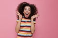 Image of excited woman 20s with curly hair shouting and throwing Royalty Free Stock Photo