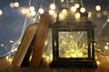 image of fairy lights inside old lantern and antique books.