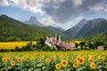 image of a fairy tale village against the beautiful landscape of tree,mountain, field of greenery and flowers. Royalty Free Stock Photo