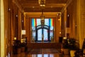 Fancy golden hallway with elaborate doorway framed by pride flags Royalty Free Stock Photo