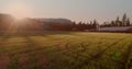 Image of farmhouse, field with trees and lake on sunny day