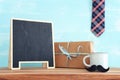 image of fathers day composition with hot cup of coffee and blackboard over table Royalty Free Stock Photo