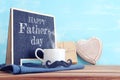 image of fathers day composition with hot cup of coffee and blackboard over table Royalty Free Stock Photo