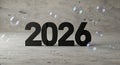 Elegant New Year 2026 Celebration with Floating Bubbles against a Concrete Backdrop Royalty Free Stock Photo