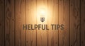 Helpful Tips - Idea Light Bulb on Wood Royalty Free Stock Photo