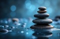 A stack of smooth stones arranged in a balanced formation on water with a Royalty Free Stock Photo