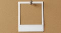 Blank instant photo frame pinned on cork board Royalty Free Stock Photo