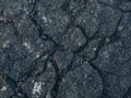 Cracked Asphalt Texture. Abstract Dark Grey Road Surface with Rock Fragments. Royalty Free Stock Photo