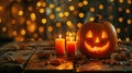 Festive Halloween Decor with Jack-o\'-Lanterns, Candles, and String Lights on Wooden Table Royalty Free Stock Photo