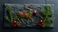 Festive Reindeer Decoration with Fir Branches and Red Bauble on Black Stone - Christmas Concept Royalty Free Stock Photo